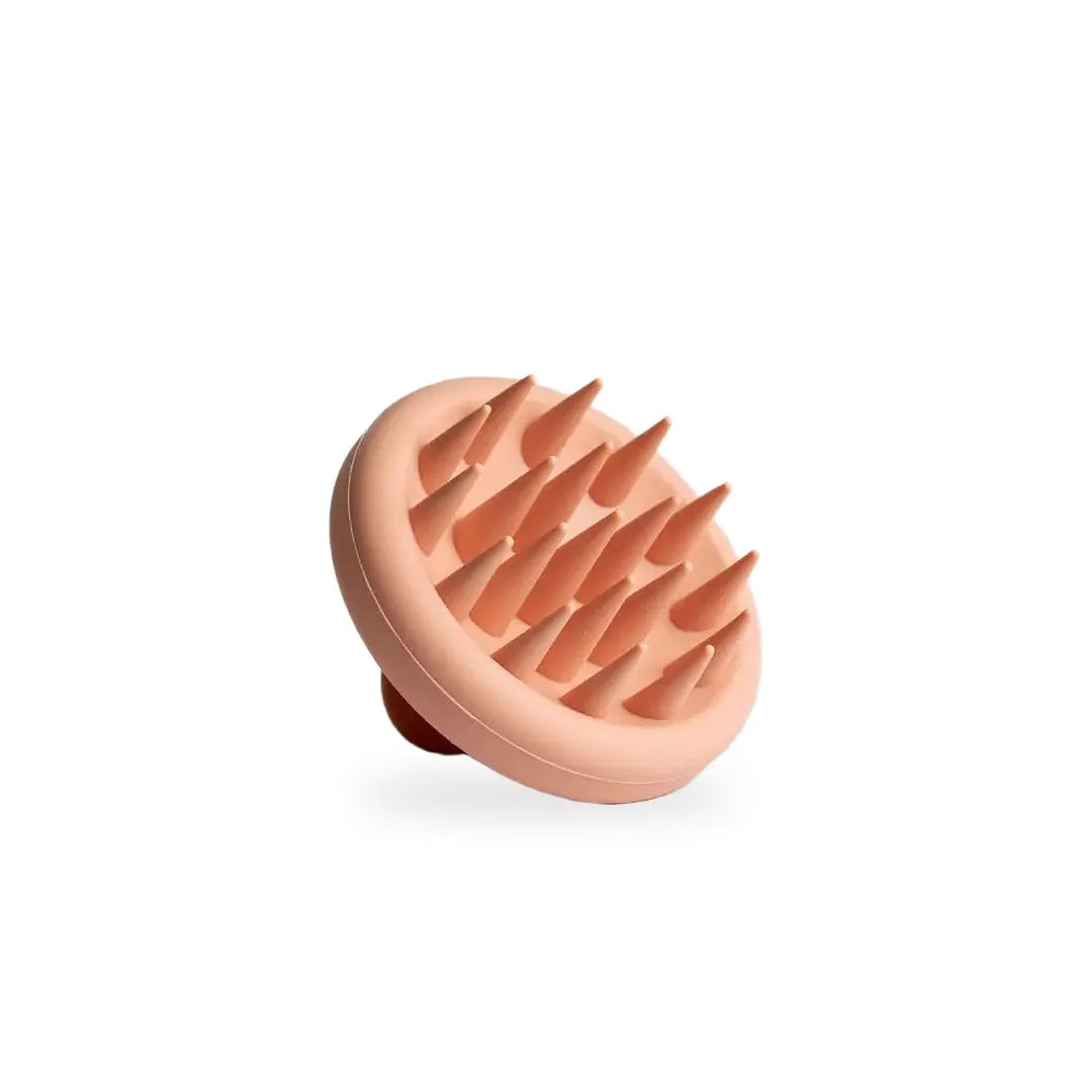 The Volyoume scalp massager, soft peach silicone bristles