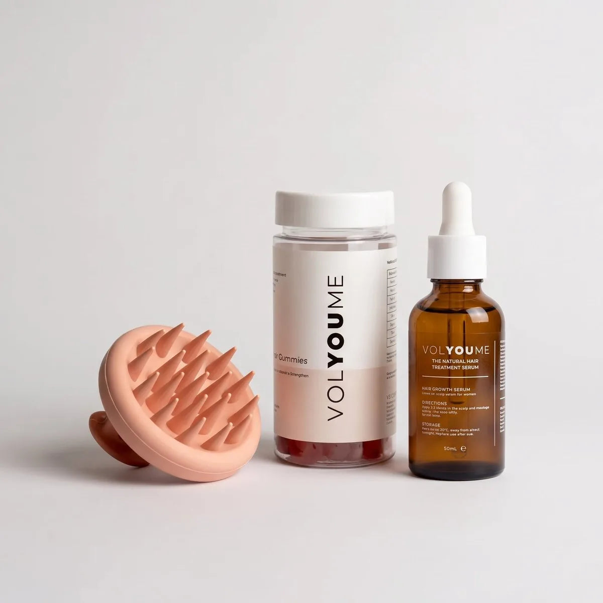The massager with the Hair Growth Serum and the Hair Support Gummies