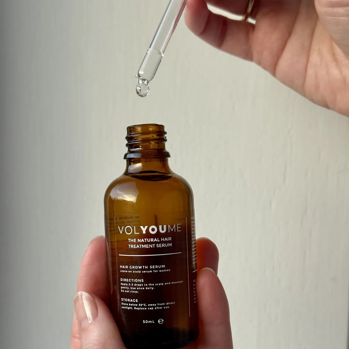 The dropper lifted from the bottle, the serum water-clear