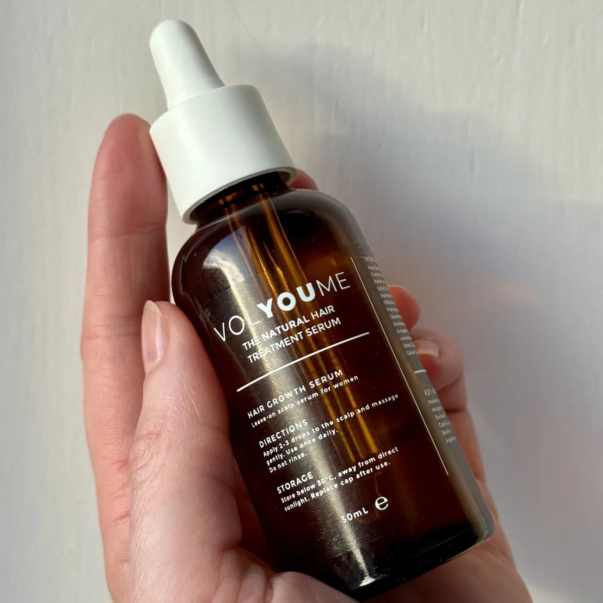 The serum held in a hand